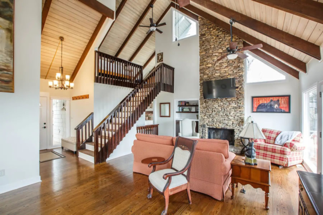 The A-frame wood beamed ceilings and two story stone fireplace are centerpieces of Appalachian Sky Mountain Cottage Rental in Big Canoe, Georgia